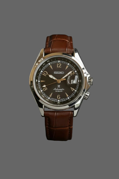 Dark dial watch with a date window and brown embossed strap.
