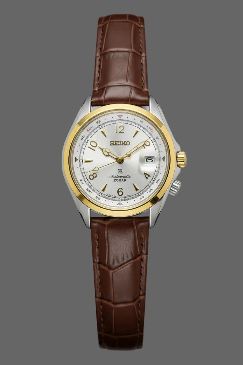 Light dial watch with gold-tone bezel accents and a brown embossed strap.