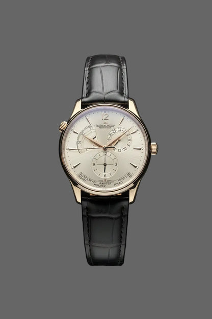 Gold-tone round watch with a light multi-section dial and black embossed strap.