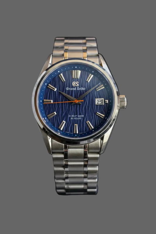 Round bracelet watch with a blue textured dial and baton markers.