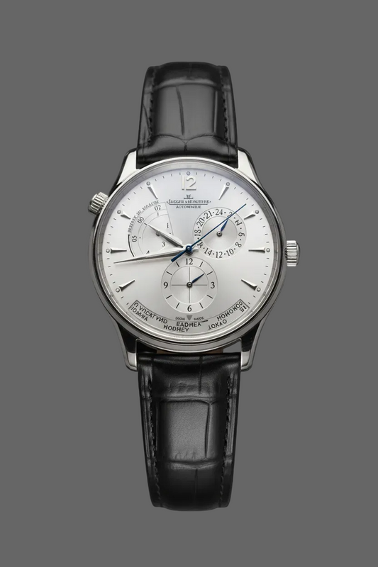 Silver-tone round watch with a light multi-section dial and black embossed strap.