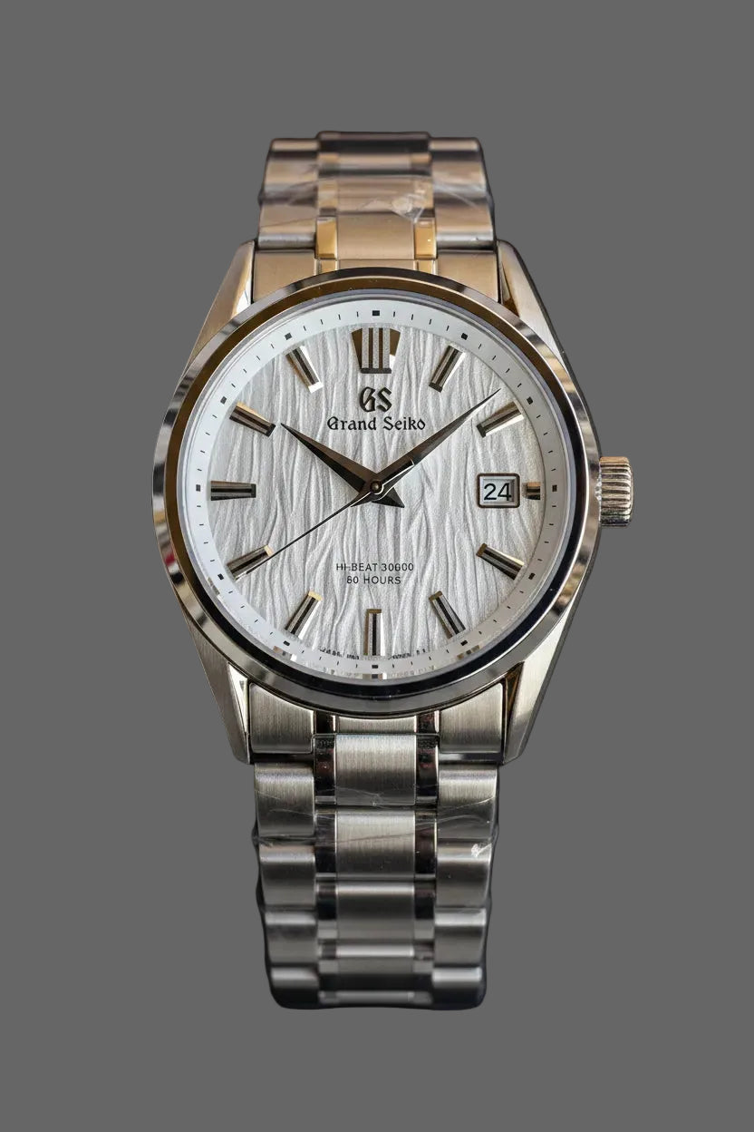Round bracelet watch with a light textured dial and silver-tone markers.
