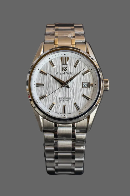 Round bracelet watch with a light textured dial and silver-tone markers.