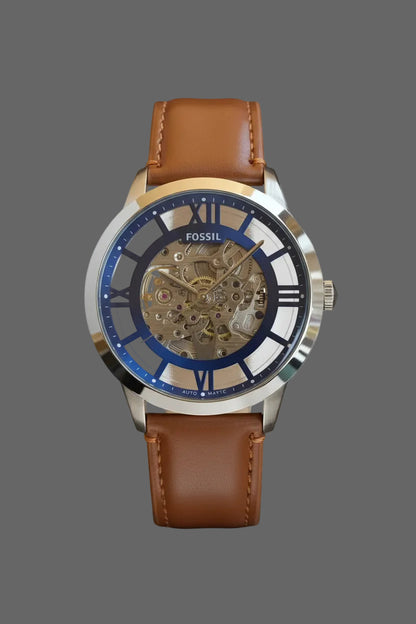 Skeleton-style watch with a blue dial surround and brown stitched strap.