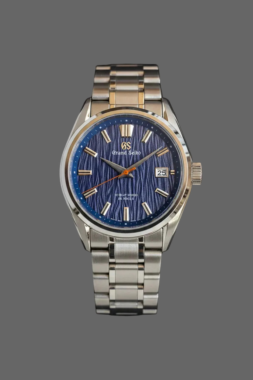 Blue textured dial watch with gold-tone accents and a silver-tone bracelet.