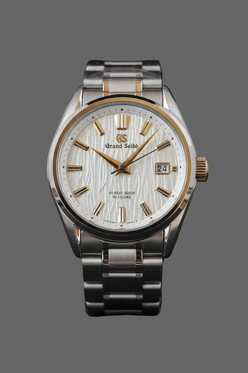 Round bracelet watch with a light textured dial and gold-tone accents.